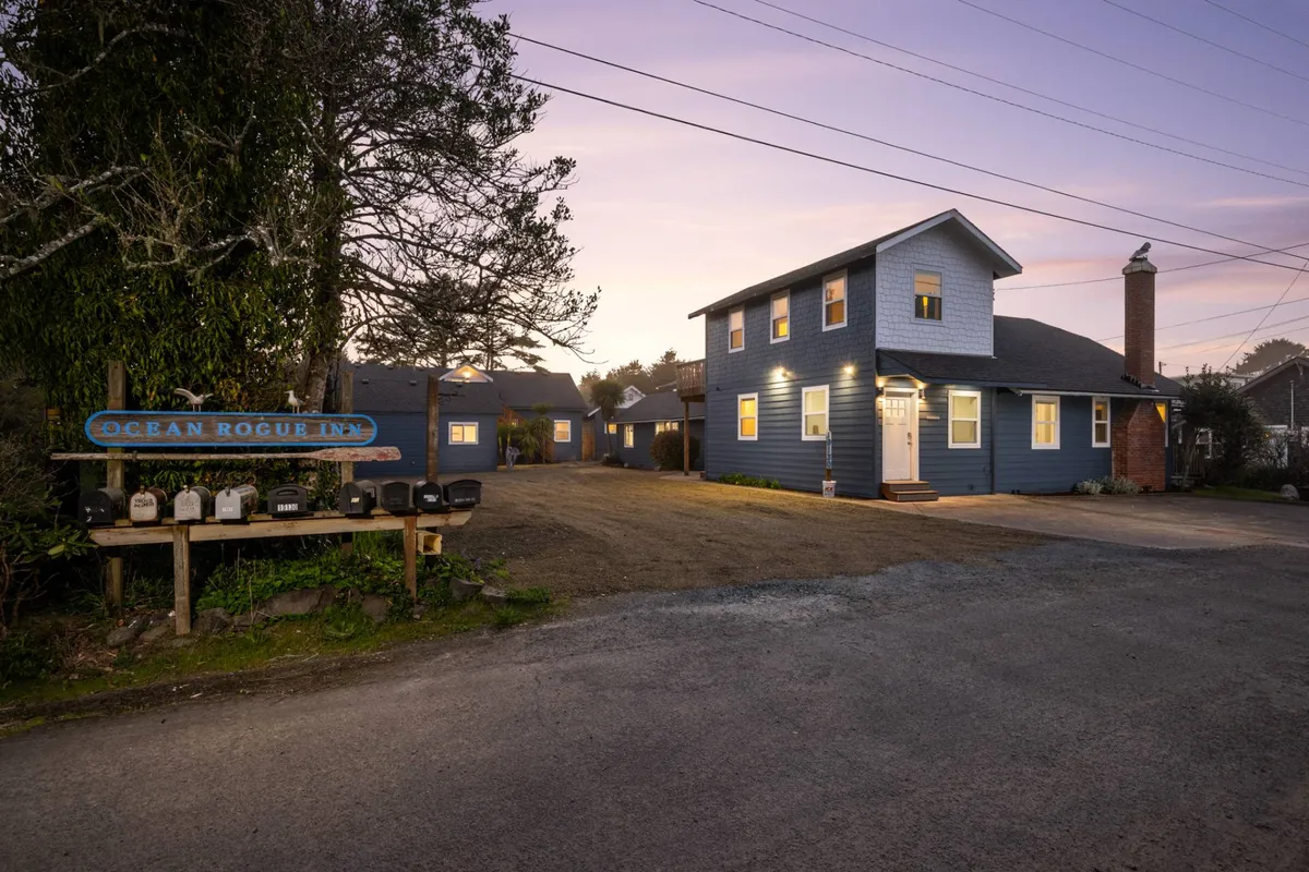 This image captures the Ocean Rogue Inn’s inviting front entrance with its signature sign and blue exterior, signaling a warm welcome for all guests, including those with pets. The visible outdoor seating area and tranquil ambiance suggest a relaxing spot to start or end an adventure with furry companions.